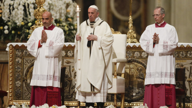 Pope Francis presides over an Easter vigil ceremony in St. Peter's Basilica at the Vatican.