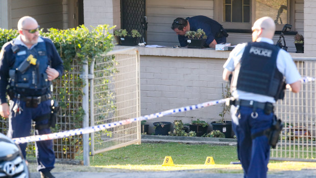 Police at the scene of the assault at a home on the Princes Highway in Figtree.