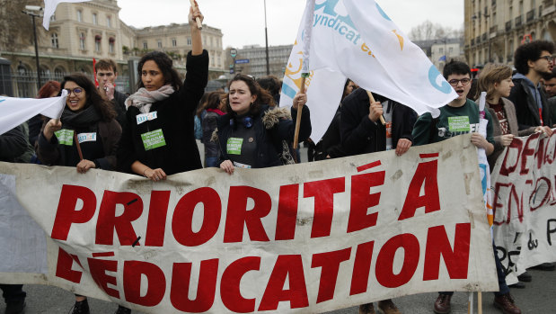 Students hold a banner reading "Priority to education" during a demonstration in Paris, on Tuesday.