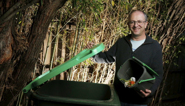 Glen Eira mayor Jamie Hyams putting out food scraps in the green waste bin for kerbside collection. 
