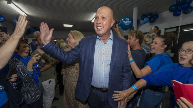 Home Affairs Minister Peter Dutton celebrating his return to the seat of Dickson while in Strathpine on election night.
