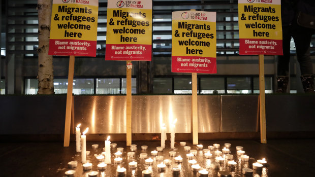 Signs and candles on a wall were placed at a vigil for the 39 lorry victims, outside the Home Office in London.
