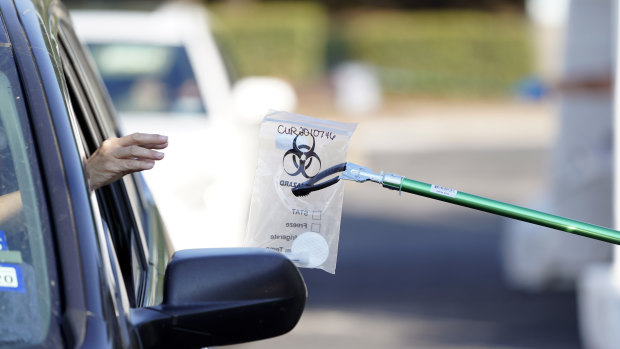 A sample is collected at a free COVID-19 testing site in Texas last week.