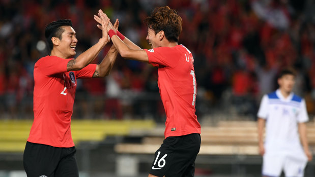 Hwang Ui-jo of Korea Rebublic  (right) celebrates after scoring a goal with Lee Yong (left)  during their win against Uzbekistan at QSAC.