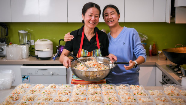Cecilia Chuah and her daughter Shanice, busy preparing about 100 meals to distribute to the homeless