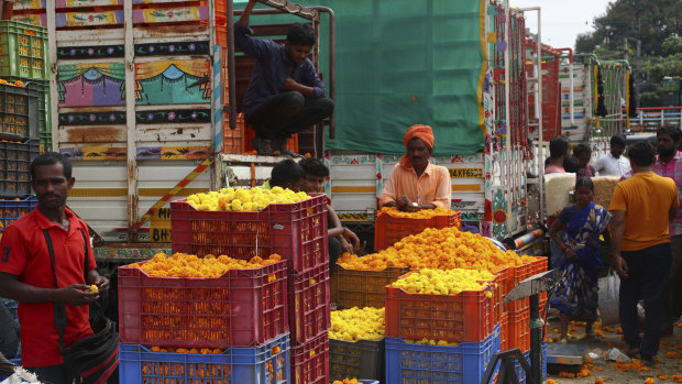 Marigold flower vendors wait for customers at a wholesale market ahead of Diwali in Hyderabad, India. Diwali is also known for its sweet treats and colourful patterns of flowers, rice or sand on the floor.