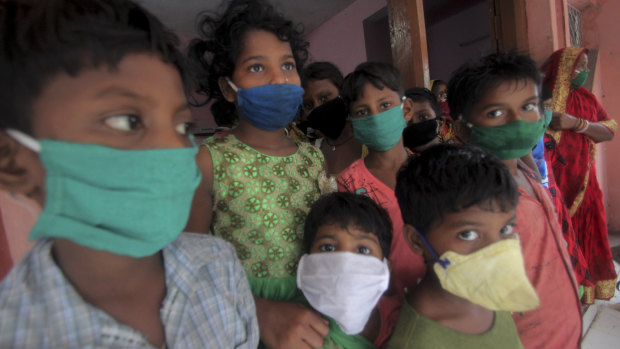 Evacuated children wear masks as a precaution against the spread of coronavirus as cyclone Amphan moved towards India in May.