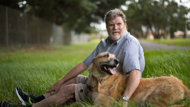 Michael Higgins, who has been diagnosed with bowel cancer, with his dog Alex.