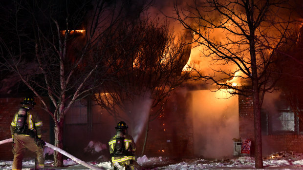 Abilene, Texas firefighters battle a house fire. Crews were only able to draw water from one hydrant because all three city water treatment plants were offline due to power outages. 