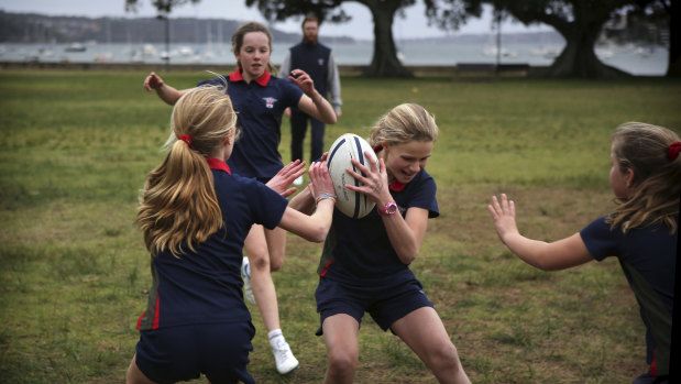Girls from Ascham School play touch football at Double Bay.