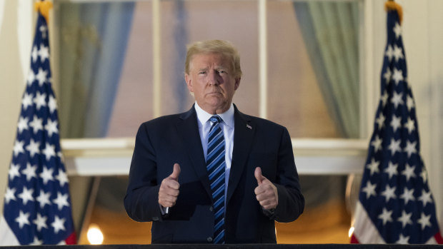 President Donald Trump gives the thumbs up on the Blue Room Balcony.