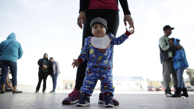 Nine-month-old Jesus Alberto Lopez with his mother, Perla Murillo, as they wait with other families in Tijuana, Mexico to request political asylum in the United States.