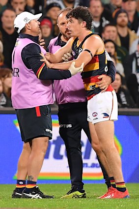 Adelaide’s Ned McHenry is attended by a trainer. 