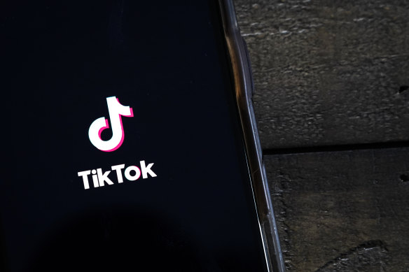 The TikTok app is displayed on an Apple iPhone.