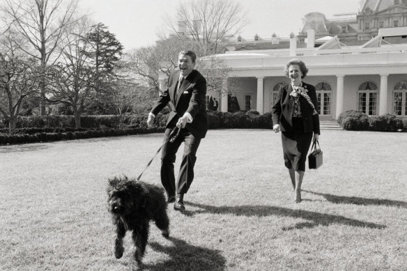 Reagan and Thatcher walk his dog, Lucky, on the White House Lawn in 1985.