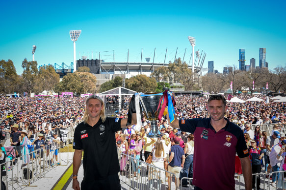 Collingwood skipper Darcy Moore and Brisbane Lions co-captain Harris Andrews with the premiership cup.