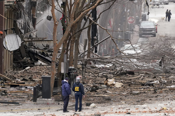 Emergency personnel work near the scene of an explosion in downtown Nashville, Tennessee, on Christmas Day.