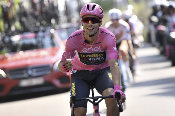 Pink jersey Primoz Roglic toasts his victory on the processional last stage into Rome on Sunday.