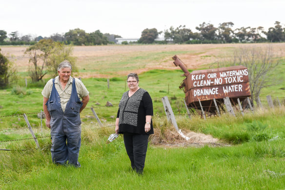John McKenzie and sister Heather Dodd in front of the protest signs against the dumping of toxic soil from the West Gate Tunnel in Bulla.