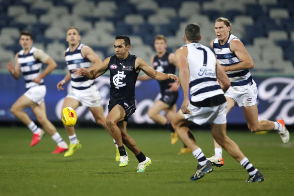 Eddie Betts finds himself surrounded as he attempts to get a kick away against Geelong on Saturday night.