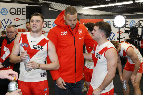 Lance Franklin celebrates with the Swans after their victory over the Bombers, during which he was subbed off with a calf injury.