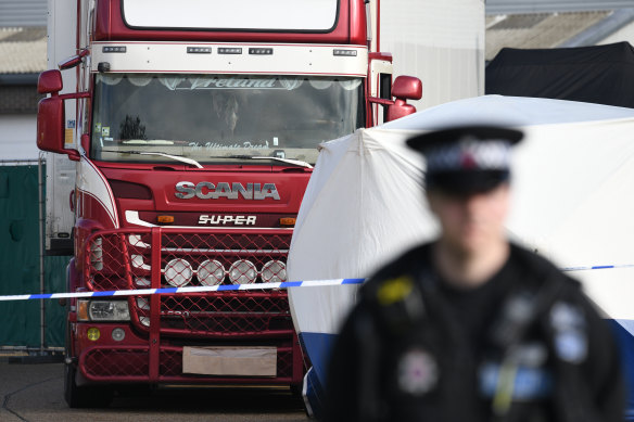 Police stand guard at the site where 39 bodies were discovered in a lorry.