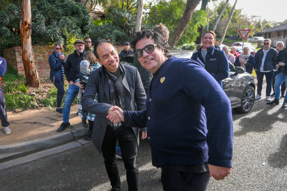 Craig Tan (left) shakes hands with the underbidder after the hammer fell.