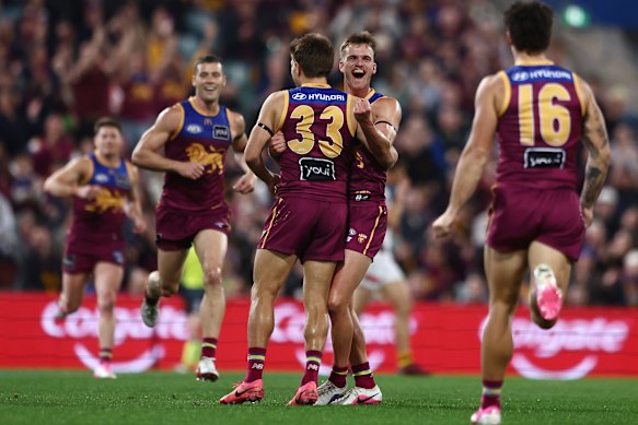 Daniel Annable celebrates his first AFL goal with teammate Zac Bailey.