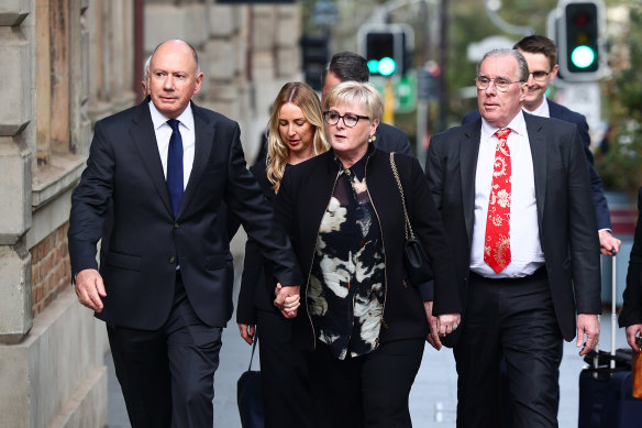 Former Minister Linda Reynolds arrives at the Supreme Court in Perth for the defamation trial, with husband Robert Reid (left) and lawyer Martin Bennett (right).