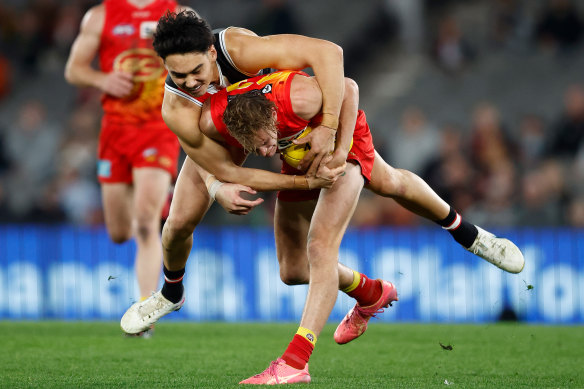 St Kilda’s Mitch Owens lays a tackle on Gold Coast’s Sam Clohesy in Saturday night’s dour affair at Marvel Stadium. 