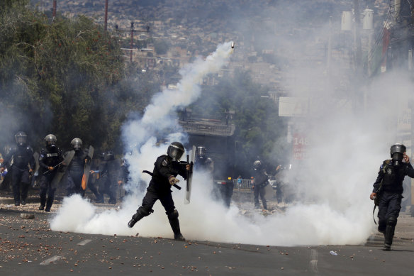 Police throw tear gas at protesters in Honduras. 