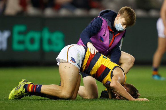Tom Doedee of the Crows lays injured during the match between the Bombers and the Crows at Marvel Stadium.