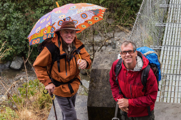 Simon Balderstone, right, and Peter Hillary, with his umbrella on a trek: “It was a joke, but it actually suited him: the perfect gentleman, perfectly attired.”