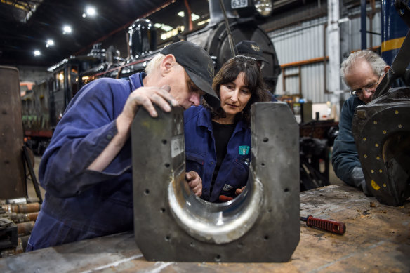 Volunteers from Mornington Rail repairing locomotive parts at the workshops.