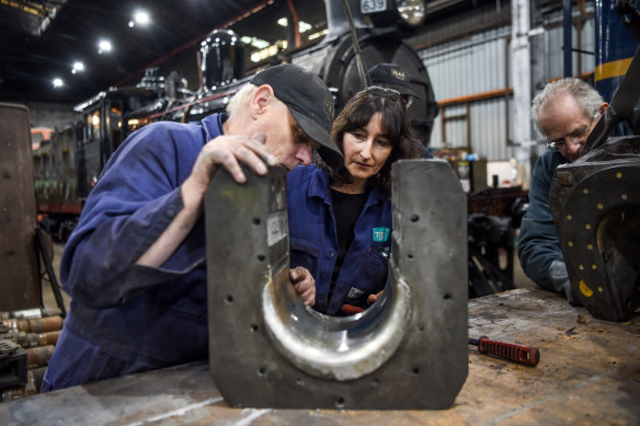 Volunteers from Mornington Rail repairing locomotive parts at the workshops.