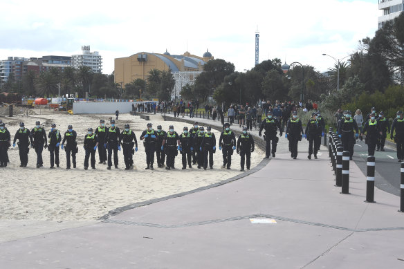 Police on the beach at St Kilda on Saturday. 