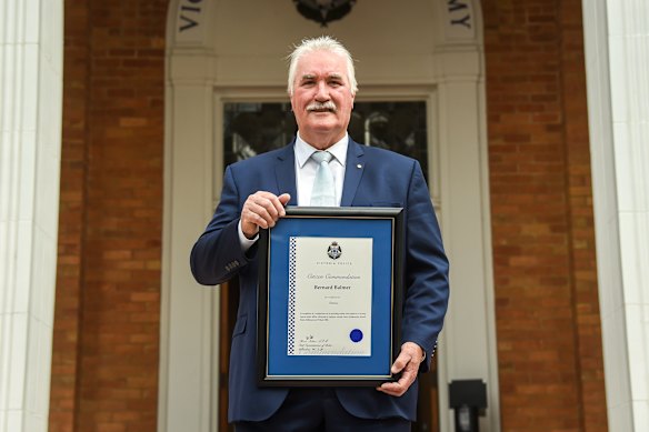 Bernie Balmer receiving a commendation award in 2022 over his actions during the 1986 Russell Street bombing. 