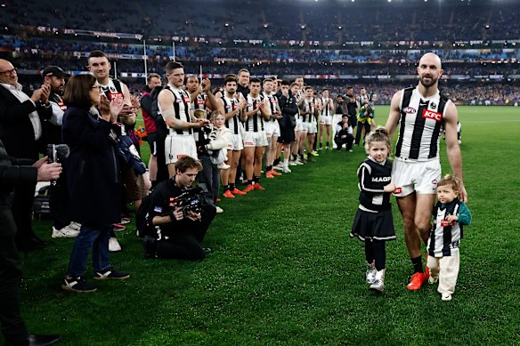 Steele Sidebottom of the Magpies is seen with children Ned and Matilda after his final match.