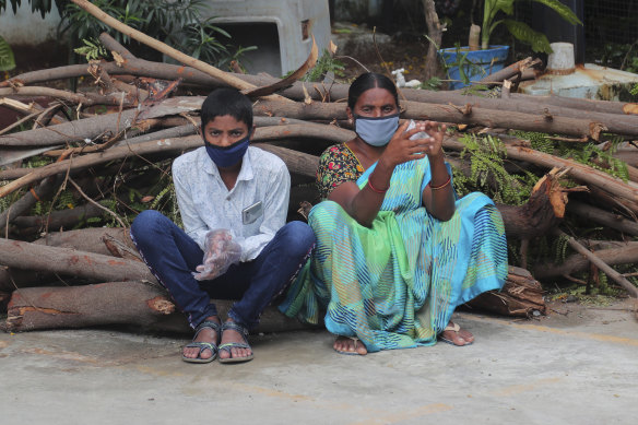 People wait to be tested for COVID-19 in Hyderabad, India, on Tuesday.