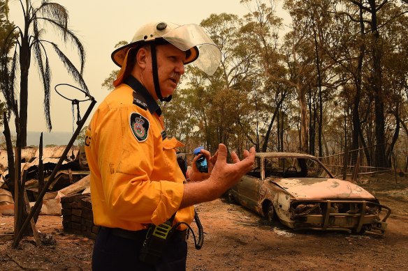 RFS official John Koole inspects a burnt-out home and out-building near Balmoral. 