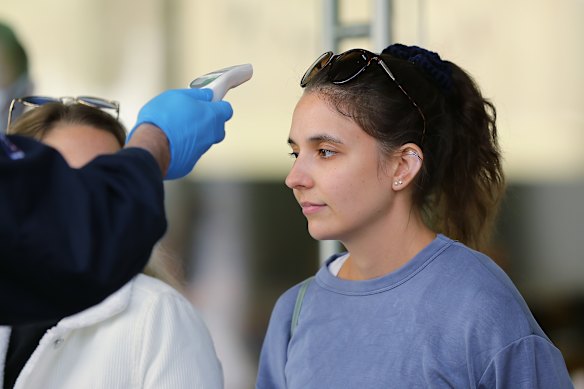 A customer has her temperature checked before entering the Bondi Junction store.