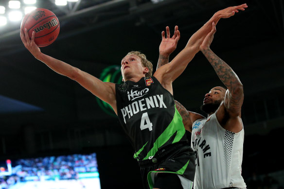 Phoenix's Kyle Adnam, left, drives at the basket during round five against Melbourne United. 