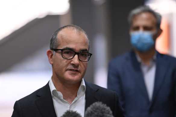 Acting Victorian Premier James Merlino announces an extension of Melbourne’s seven-day lockdown as Chief Health Officer Brett Sutton looks on.
