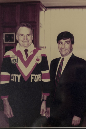 Politis (at right) with Ford global president Harold “Red” Poling, wearing a Roosters jersey, which Politis’ dealership City Ford had sponsored.