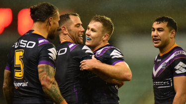 Captain fantastic: Storm skipper Cameron Smith (2nd from left) celebrates win over the Dragons at WIN Stadium in Wollongong.