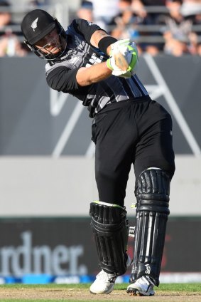 Long handle: Martin Guptill launches one of his nine sixes into the grandstand at Eden Park.