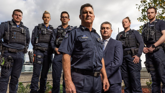 Acting Commissioner Bob Hill (center) and Detective Inspector Michael Daly (suit) and Viper officers.