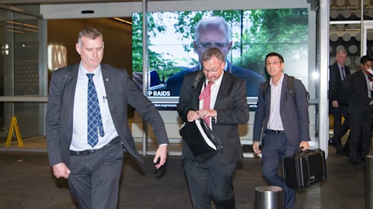 AFP depart the ABC studios after raiding them for information.