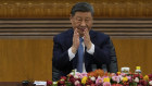 Chinese President Xi Jinping applauds during a meeting with international business in Beijing.