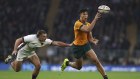 Joseph Sua’ali’i taps the ball to a support player during the Wallabies’ win against England.